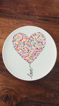 a plate with a heart shaped balloon on it