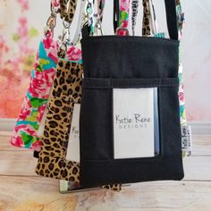 the key holder is made out of black canvas and has leopard print fabric, with a name tag attached to it