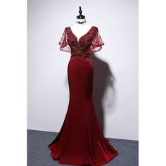 This Burgundy V-neck Mermaid Evening Gown is perfect for making a statement at any special occasion. The fitted silhouette features a deep V neckline and a ruffle detail that cascades down the body of the dress. The mermaid silhouette hugs the body to showcase your curves while the floor-length skirt adds a touch of drama. The beautiful burgundy color adds a classic elegance to the dress. This gorgeous dress is also available in plus sizes to ensure that everybody can look and feel their best Burgundy Dress Long, Ruffle Formal Dress, Red Mermaid Gown, Dark Dresses, Formal Dress Plus Size, Victorian Style Wedding Dress, Burgundy Wedding Dress, Dark Lighting, Nontraditional Wedding Dress