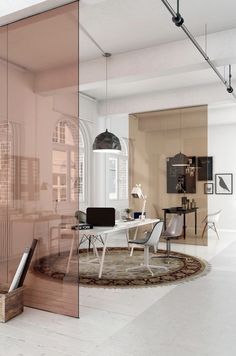 an office with glass walls and furniture in the center, along with a rug on the floor