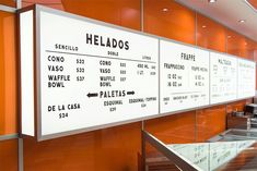 an orange and white restaurant with menus on the wall