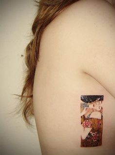 a woman with a tattoo on her shoulder