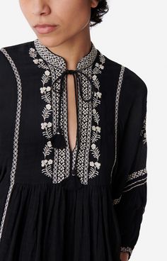 Vanessa Bruno - Blouse bohème par excellence, Baltik présente une encolure tunisienne avec de fins liens dotés de pompons et de perles, et de grandes manches bouffantes grâce à ses bas élastiqués.Blouse en viscose.Encolure tunisienne réhaussée de liens ornés de pompons et perles.Manches bouffantes 3/4 elastiquées au bas.Détails de plis devant et dos.Détails de broderie.Forme légèrement oversize. Couleur : Noir - Matière principale : 100% viscose.  Doublure principale : 100% viscose.  Broderie : Elegant Blouses, Vanessa Bruno, Co Ord Set, Bags Shoes, Embroidery Art, Black Blouse, Tote Bags, Designer Dresses, Shop Now