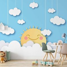 a child's room with clouds, sun and teddy bear hanging from the ceiling