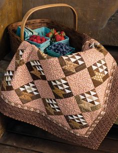 a basket filled with fruit sitting on top of a wooden floor next to a bag