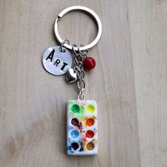 a close up of a key chain on a wooden surface