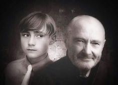 an older man and young boy are posing for a black and white photo in front of a grungy background