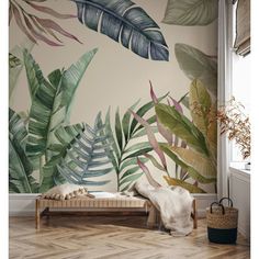 a wall mural with tropical leaves and plants in the background, on a wooden floor next to a window