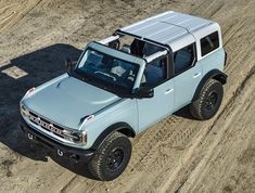 an off - road vehicle is parked in the dirt