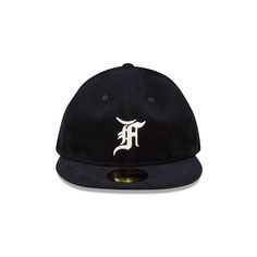 The Fear of God Essentials Corduroy Navy 59FIFTY Fitted Cap features an unstructured crown with an embroidered Fear of God logo at the front panels, a matching MLB Batterman logo at the rear, and a green undervisor. Flat Cap Fitted Hat With Embroidered Logo For Streetwear, Embroidered Logo Flat Cap For Baseball Season, Fitted Flat Cap With Embroidered Logo For Streetwear, Embroidered Logo Fitted Hat For Streetwear, Fear Of God Logo, God Logo, Crown Silhouette, The Fear Of God, Floral Camo