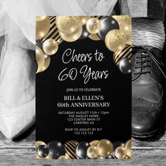 a black and gold 50th birthday party with shoes, balloons and streamers on the floor