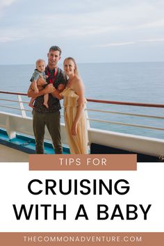 a man, woman and baby standing on a cruise ship deck with the ocean in the background