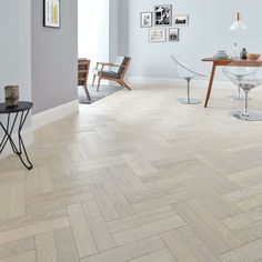 an image of a room with wood flooring on the walls and pictures on the wall