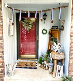 the front door is decorated with wreaths and decorations