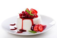 a dessert with berries and cream on a white plate