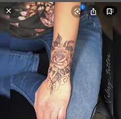 a woman with a rose tattoo on her arm