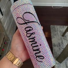 a person holding up a pink case with the word sparkle on it