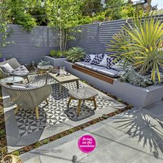 an outdoor seating area is shown with plants and potted trees in the back yard