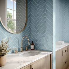 a bathroom with blue and white herringbone tile on the walls, countertop, and sink