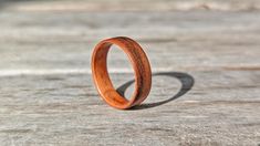 a wooden ring sitting on top of a piece of wood