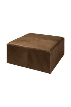 a brown leather ottoman sitting on top of a white floor