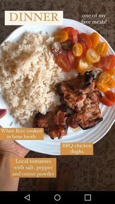 a white plate topped with meat, rice and veggies next to a hand