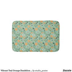 a bath mat with flowers on it and the words teal orange dandelion