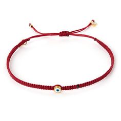 a red string bracelet with an evil eye charm