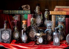 many bottles are sitting on a red cloth