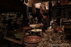 people are sitting at a table with food in front of them