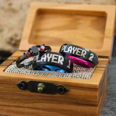 wooden box with three different colored rings in it