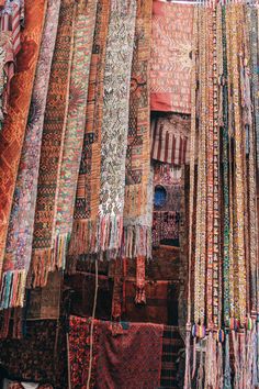 an assortment of colorful carpets and rugs for sale