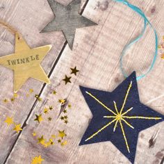 three wooden stars with the words twinkle written on them and some string attached to them