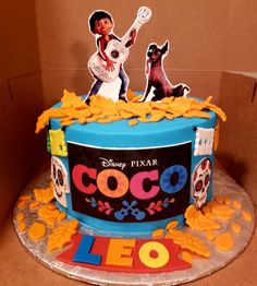 a birthday cake decorated with the theme of coco and her dog