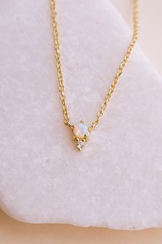 Our Odessa Opal Necklace is a piece you’ll fall in love with! Featuring a mesmerizing lab opal stone set in 14k gold-plated brass, this necklace adds a touch of elegance to any look. Whether you’re wearing it while running errands or for a glamorous night out, this versatile necklace is sure to become a new staple in your collection. Trust us - you'll be grabbing this one first from your jewelry box. NECKLACE FEATURES Material: Brass, Lab Opal Stone Dimensions/Size: 15.75" length + 2.25" extende Delicate Gold Opal Jewelry, Dainty Opal Pendant Necklace, Elegant Opal Clavicle Chain Jewelry, Elegant Ethiopian Opal Gemstone Necklaces, Elegant Opal Necklaces With Adjustable Chain, Yellow Gold Opal Pendant Necklace, Delicate Gold Opal Necklace, Dainty Opal Birthstone Necklaces, Elegant Ethiopian Opal Necklace In Yellow Gold