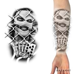 an arm tattoo with joker playing cards on the wrist and behind it is a chain link fence