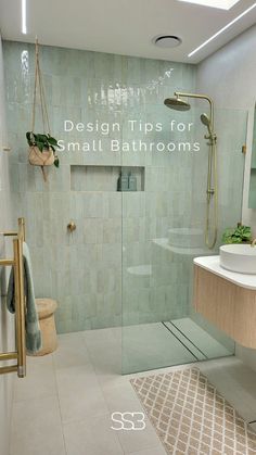 a bathroom with a glass shower door and tiled walls