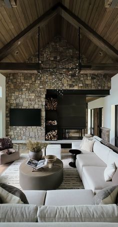 a living room filled with furniture and a flat screen tv mounted to the side of a wall