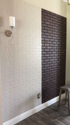 an empty room with a white brick wall