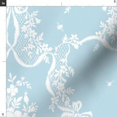 a blue and white wallpaper with floral designs on the side, in an ornate pattern