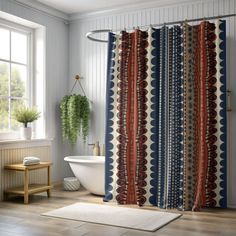 a bathroom with a shower curtain, rug and bathtub in the middle of it