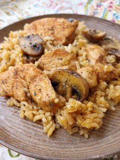 chicken and mushrooms are served over rice on a plate