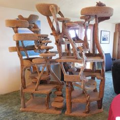 the cat tree is made from wood and has multiple levels to climb up it's sides