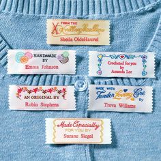 four different labels on a blue shirt with white writing and colorful threadwork around the edges