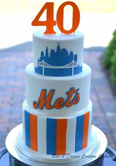 a cake with the number 40 on it is decorated in blue, orange and white stripes