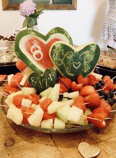 a bowl filled with fruit and vegetables on top of a table