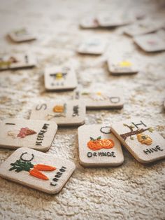 several embroidered badges with words and pictures on them sitting on the floor next to each other