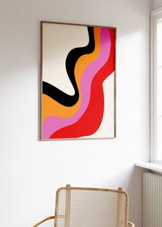 a painting hanging on the wall next to a chair in a room with white walls