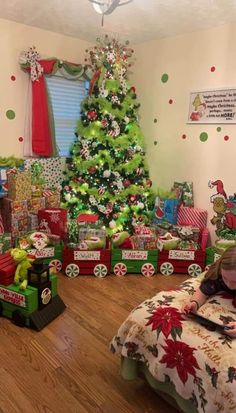 there is a christmas tree in the corner of this room with presents on the floor