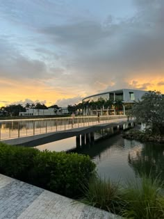 a bridge over a body of water with buildings in the background